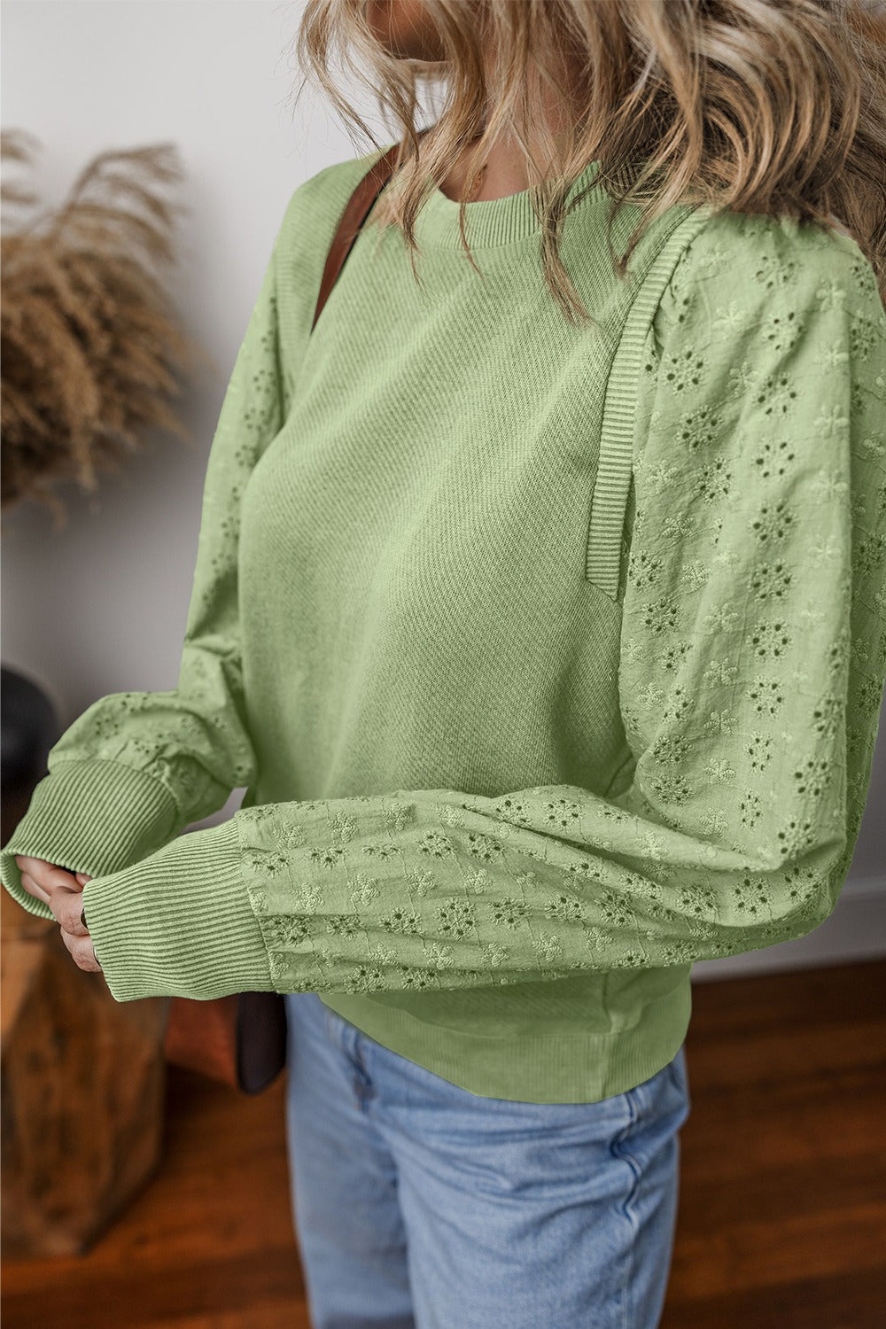  Eyelet Round Neck Long Sleeve Sweatshirt.